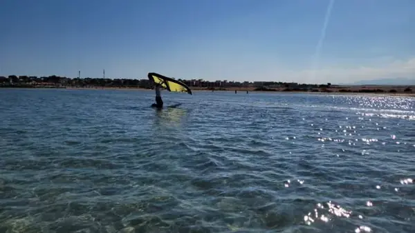 Student practicing with a yellow wing on the water