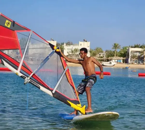 Windsurfer with a red sail