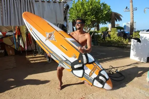 Instructor holding a windsurf board at the school