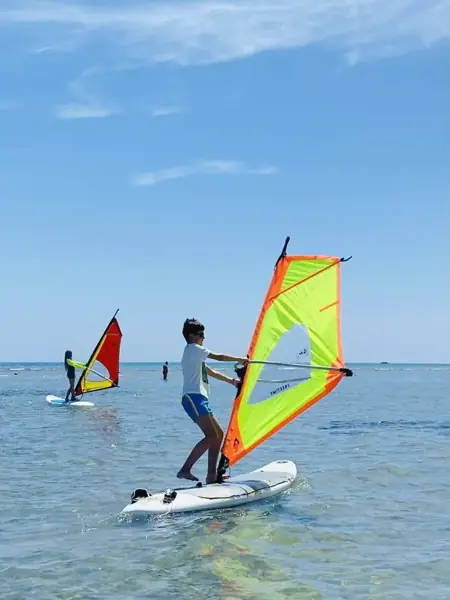 Kids learning to windsurf