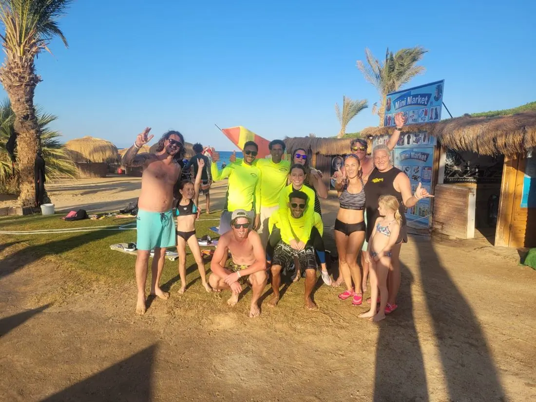 Families and the Kite Fly team on the beach