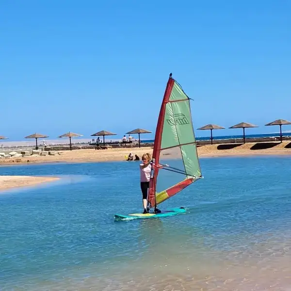 Guest windsurfing in calm water