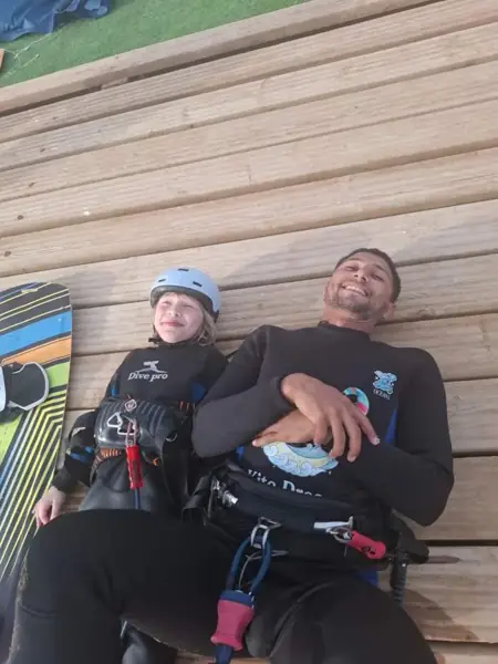 Instructor and child resting on the deck after a lesson